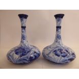 A pair of Moorcroft (for Macintyre) pottery vases of squat, bulbous form with narrow,