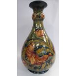 A Moorcroft pottery bottle vase of ovoid form with a short, tapered, bulbous knopped,