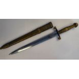 A German military dagger with a moulded brass handle pommel and hilt,