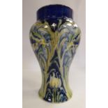 A Moorcroft pottery Florian Ware vase of tapered, waisted baluster form with an upstand rim,