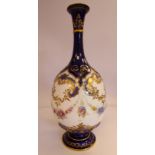 A Royal Worcester moulded and gilded midnight blue glazed china ovoid shaped bottle vase, the long,