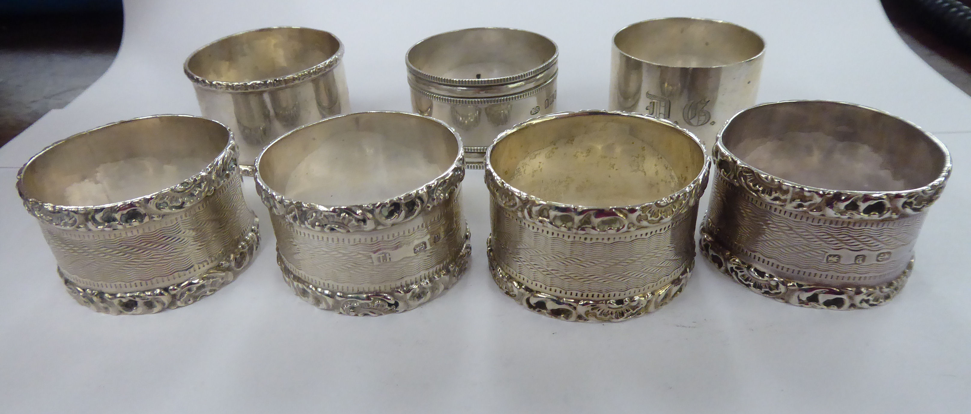 Seven variously decorated silver napkin rings mixed marks 11