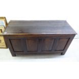 A 19thC country made stained oak and pine four panelled chest with straight sides and a planked,