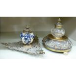 Two late Victorian cast brass ink stands, one with a clear glass reservoir, the other,