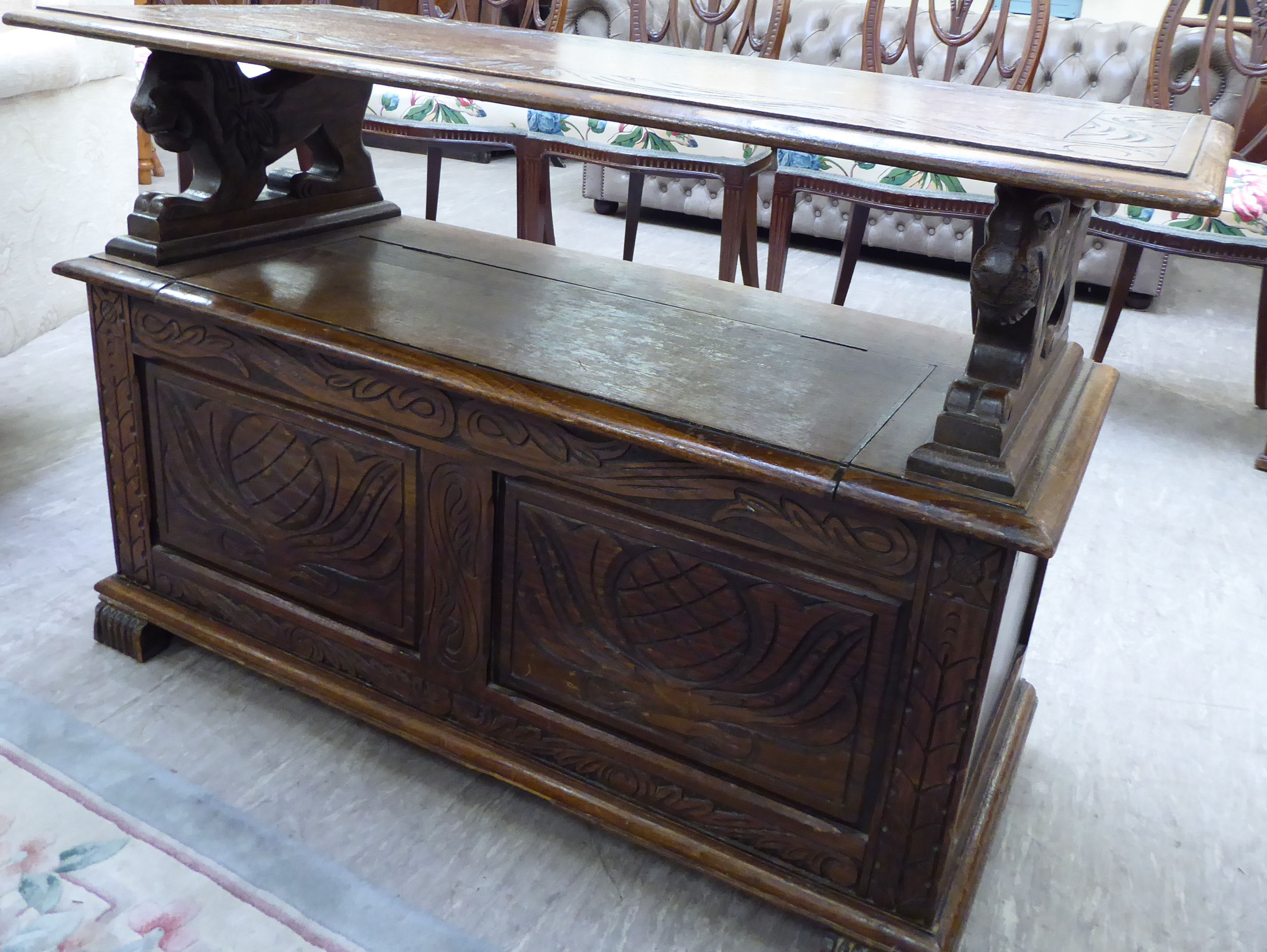 A 1920s/30s oak monk's bench with lion carved arms and a hinged seat, - Image 5 of 6