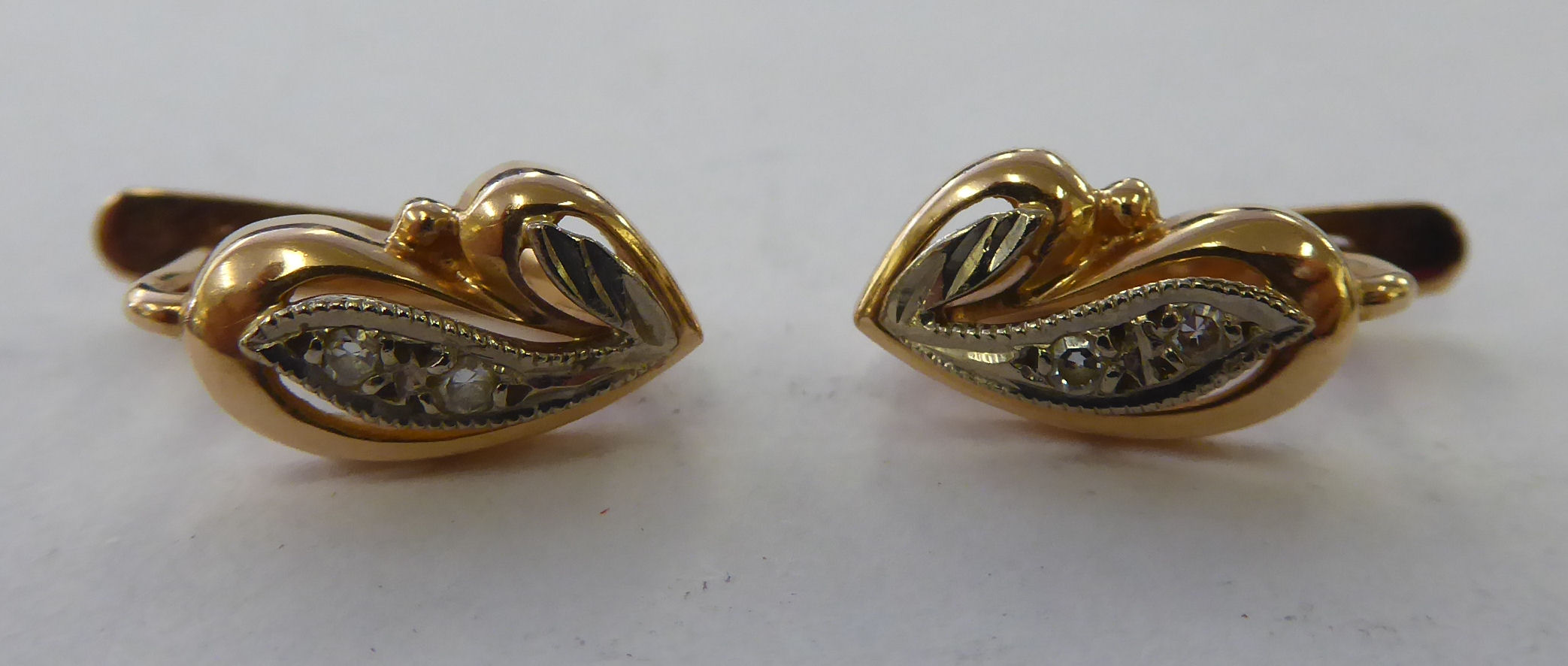 A pair of gold earrings,