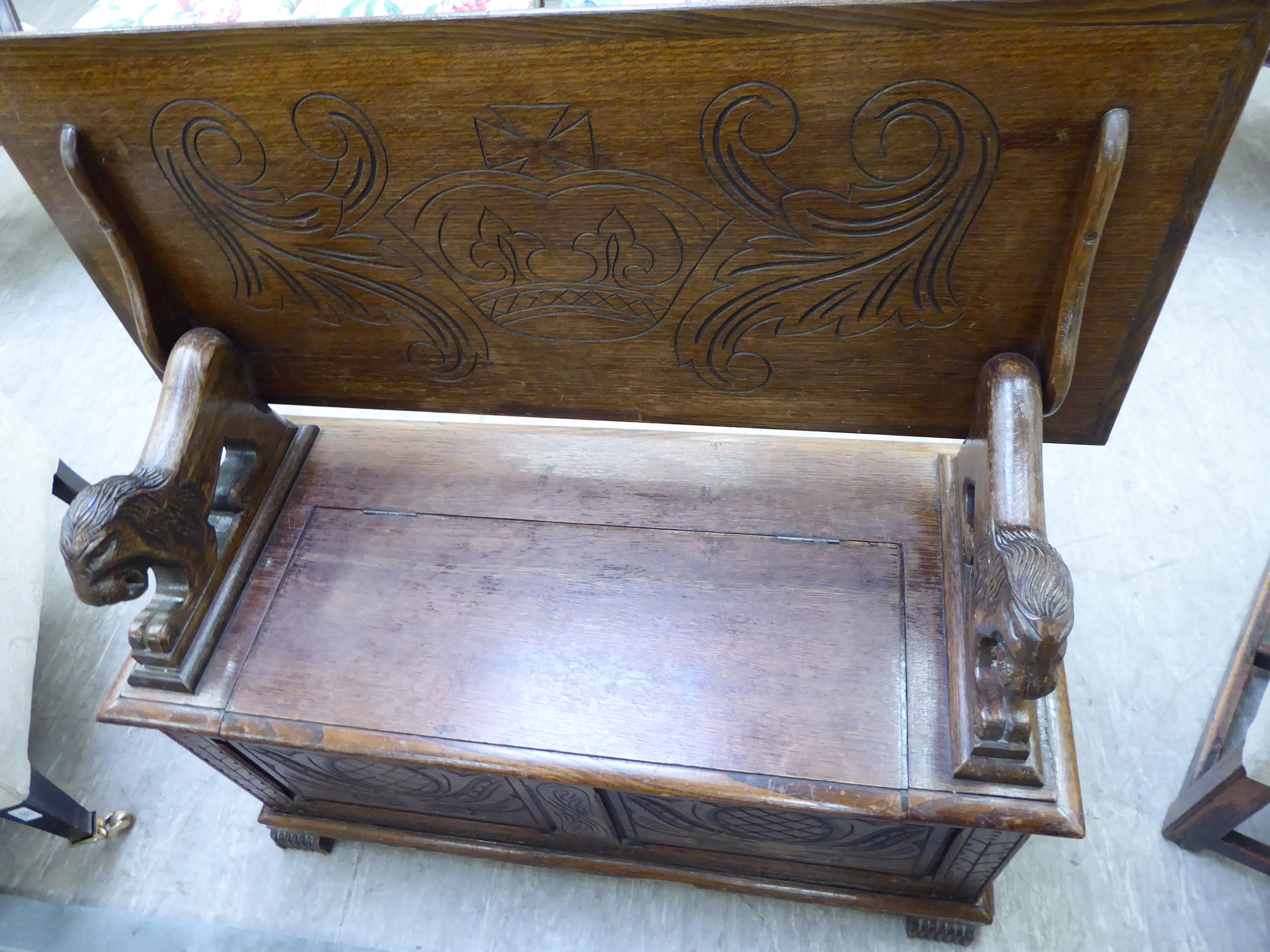 A 1920s/30s oak monk's bench with lion carved arms and a hinged seat, - Image 2 of 6