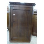 A George III oak hanging corner cabinet,