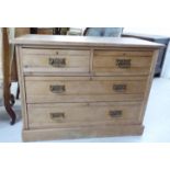 A 1920s bleached pine dressing chest, the two short/two long drawers with cast brass bail handles,