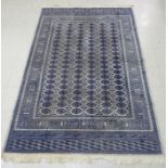 A Bokhara rug with six columns of twenty guls on a blue/grey ground 60'' x 86'' LAB