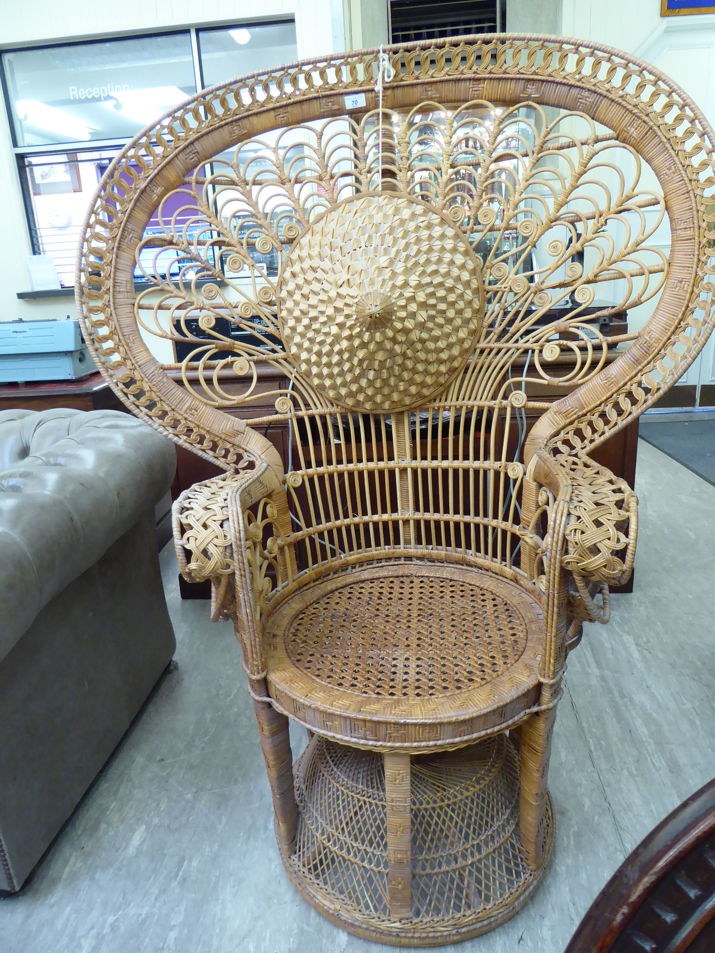 A Woodstock woven cane peacock chair;