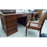 A modern Chinese fruitwood nine drawer twin pedestal desk,