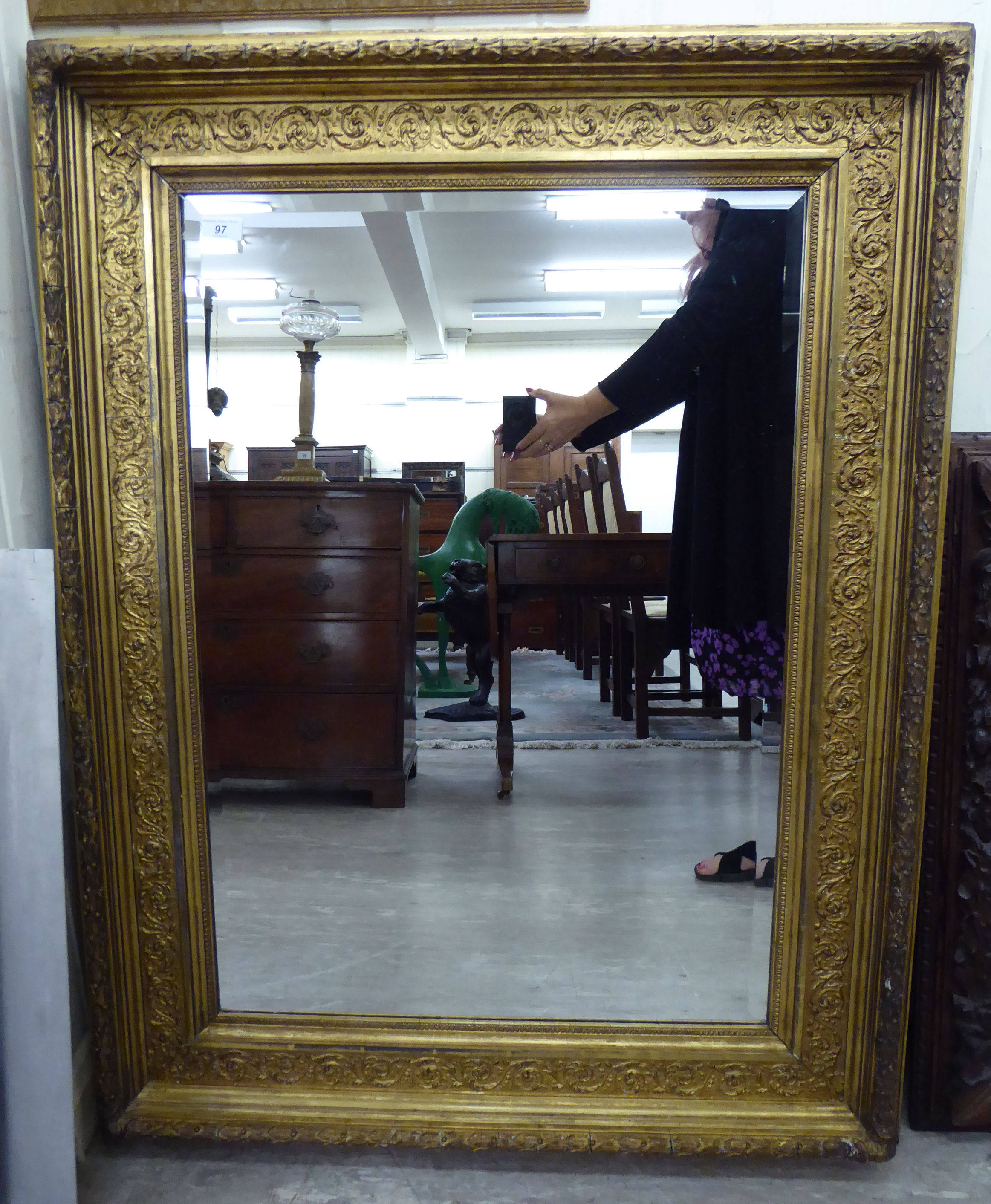 A late 19thC mirror, the bevelled plate set in a foliate moulded,