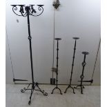 A modern black enamelled steel, freestanding triple candleholder,