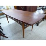 A 1970s teak coffee table, the lozenge shaped top, over a slatted undershelf,
