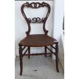 A child's William IV mahogany framed chair with a carved back and woven cane seat,