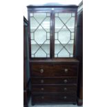 A mid 19thC mahogany secretaire cabinet-on-chest with two astragal glazed doors and four drawers,