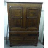 A late 18th/early 19thC honey coloured oak press cupboard, comprising a pair of doors,