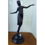 An modern Art Deco inspired cast and patinated bronze figure,