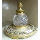 A late Victorian cast brass inkstand with a wrythen moulded clear glass reservoir OS1
