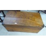 An early 20thC camphorwood chest with a hinged lid and opposing cast metal handles 15''h 35''w