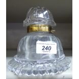 A late Victorian clear glass bell design inkwell with a hinged lid OS1