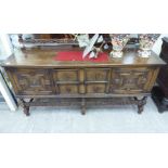 A 1920s oak sideboard with two drawers and two doors,