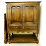 A Georgian style country made oak cupboard, comprising a pair of fielded panelled doors,