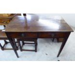 An early 19thC mahogany side table with a single drawer, raised on square,