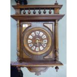 A late 19thC stained beech and walnut cased wall clock of architectural form;