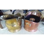 Two similar late Victorian copper and brass helmet shaped coal scuttles with swing-top handles