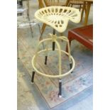 A cream painted metal stool,