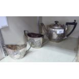 A late Victorian bachelor's silver three piece tea set of oval form,