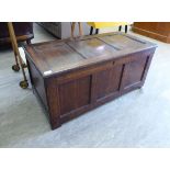 A late 18thC oak coffer with a tri-panelled front and a hinged lid,