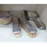 A four piece silver mounted and bead bordered dressing table set comprising a hand mirror,