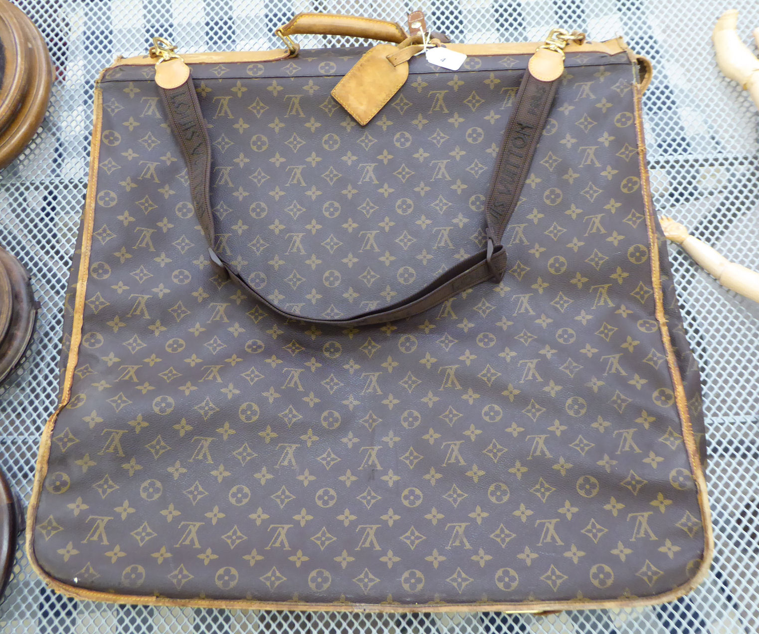 A Louis Vuitton suit carrier/holdall with brown hide handles,