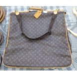 A Louis Vuitton suit carrier/holdall with brown hide handles,