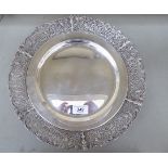 A white metal presentation salver with an applied profusely fret cast rim,