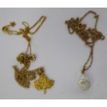 Gold coloured metal neckchains and pendants 11