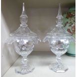 A pair of cut crystal pedestal sweet jars with finials on the domed covers 12''h OS5