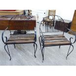 A pair of Victorian style cast iron garden open arm chairs with slatted teak seats,