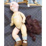 An early 20thC Heubach Koppelsdorf bisque head doll with weighted sleeping eyes and painted