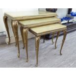 A nesting set of three modern gilt metal coffee tables,