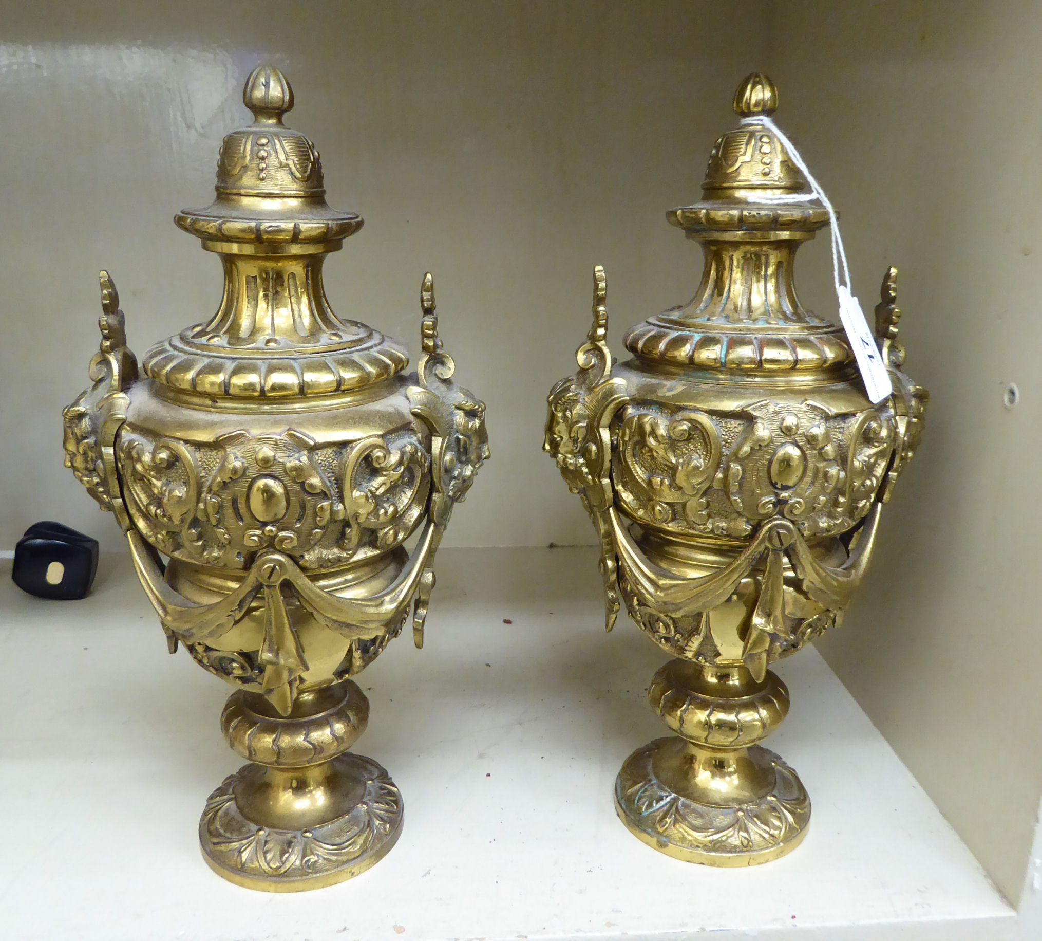 A pair of mid 20thC Victorian design cast brass cassoulets,