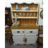 A modern painted pine dresser with a two tier plate rack with two drawers and two panelled doors,