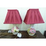 A pair of Moorcroft pottery Magnolia pattern table lamps of bulbous form 7''h with red fabric