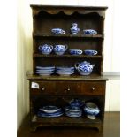 An early 20thC stained pitch pine miniature dresser with open shelves and three drawers 22''h
