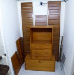 A two modular section Ladderax style teak unit,