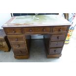 A late 19th/early 20thC lady's mahogany desk with an inset green hide scriber,