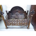 A late 19thC cast iron fireback and basket 17''h 22''w 11''deep BSR